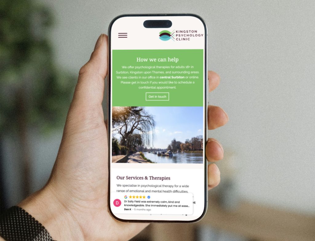 showing a hand holding a mobile with a website mockup, created by web designer kingston